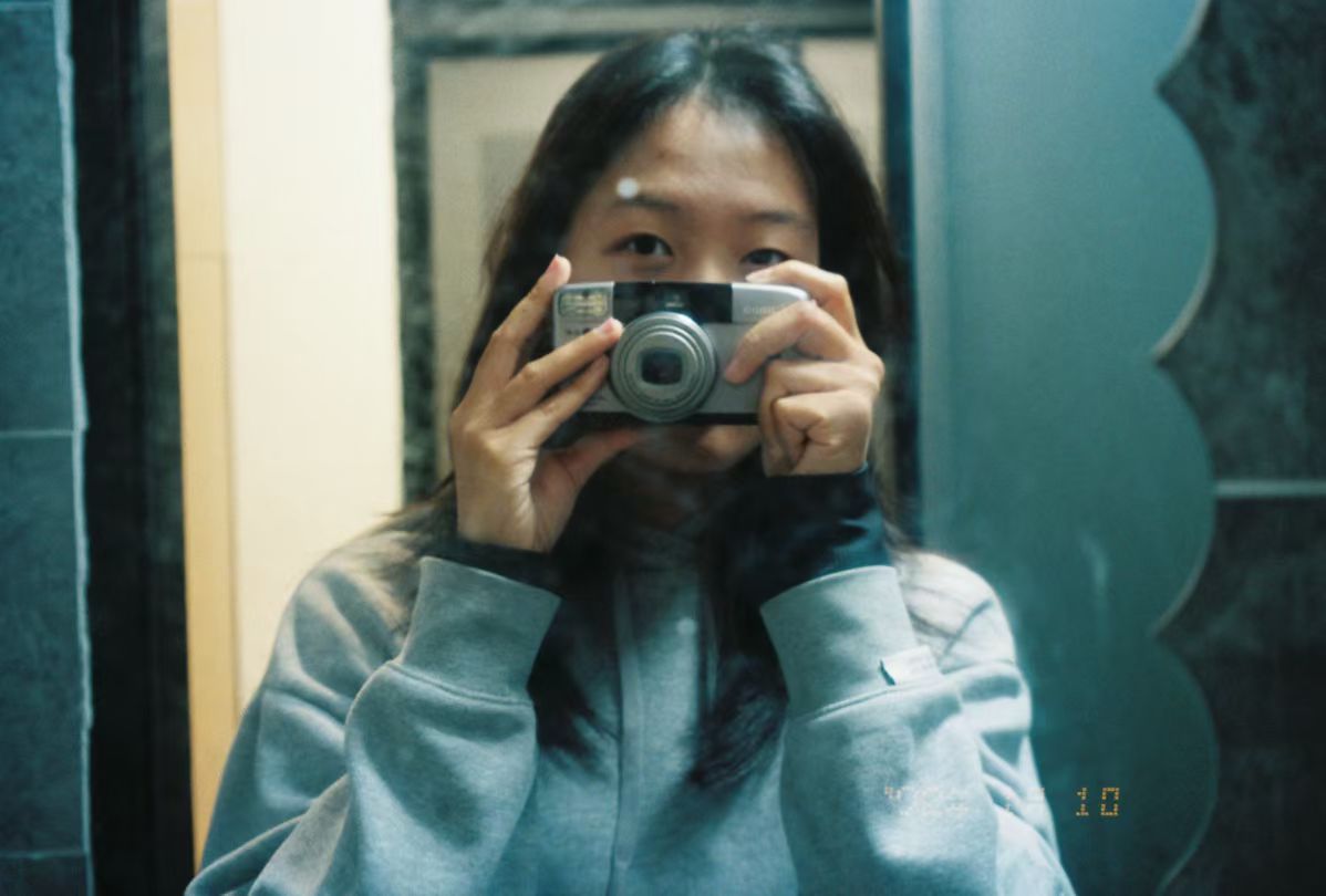 Martina Jiang taking a self-portrait with a camera