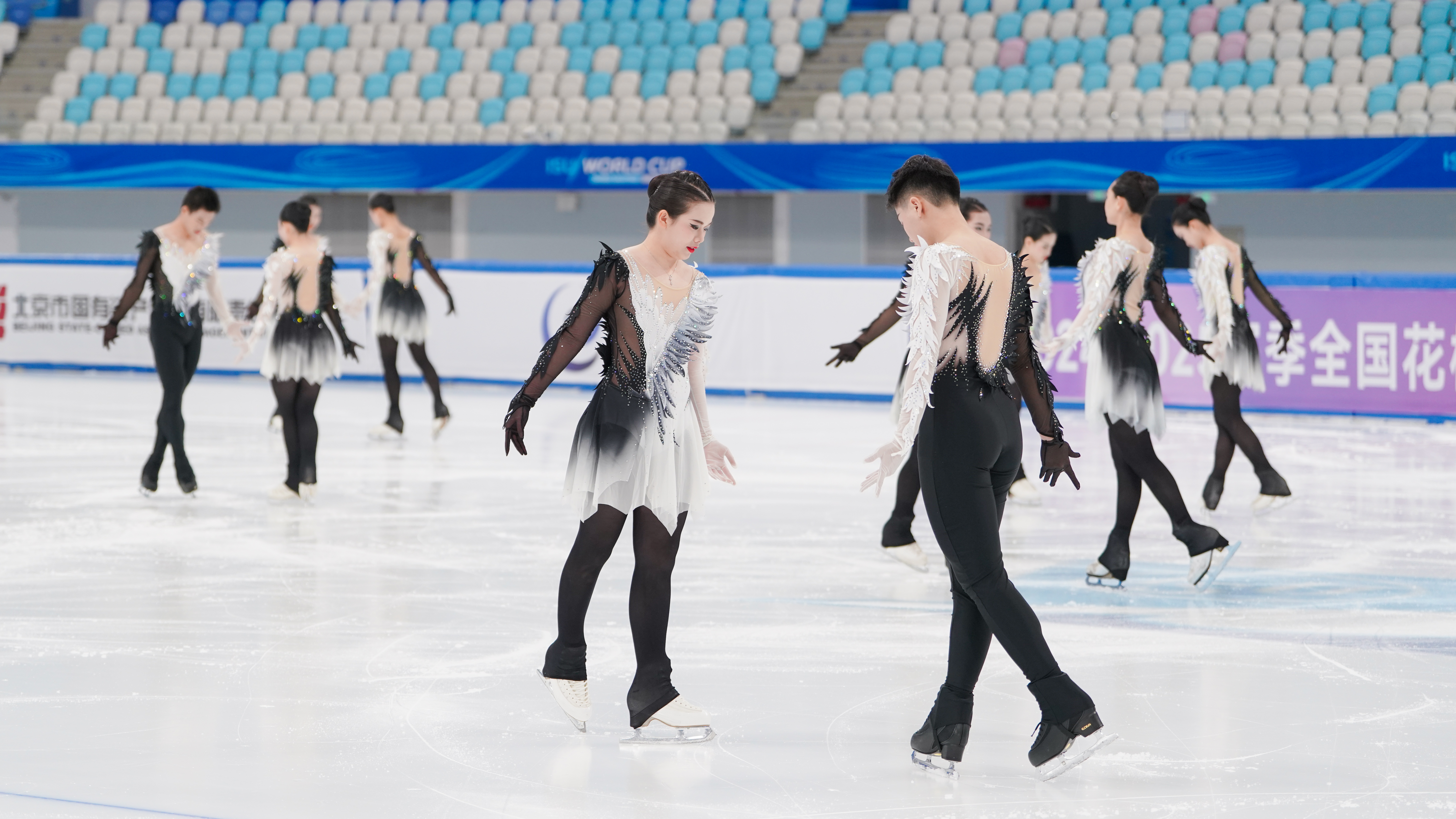 Figure skaters practising together on the ice